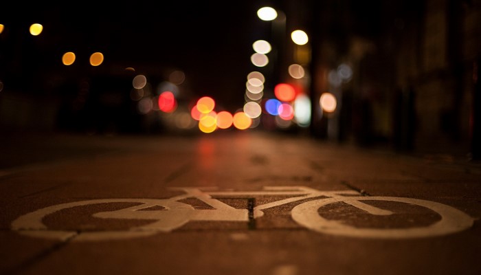Night street with bokeh lights and bicycle lane marking