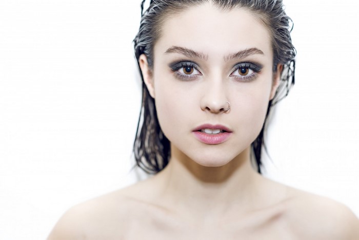 Woman with wet hair and smoky eye makeup