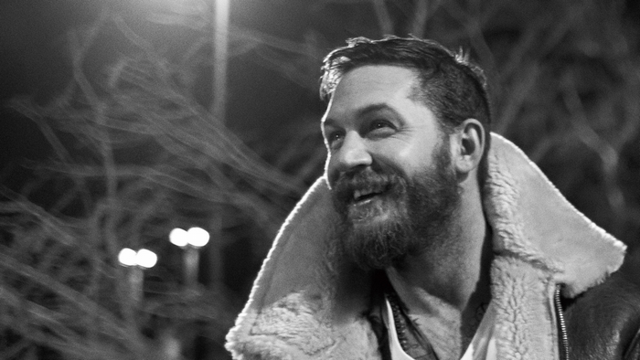 Tom Hardy in a bomber jacket at night