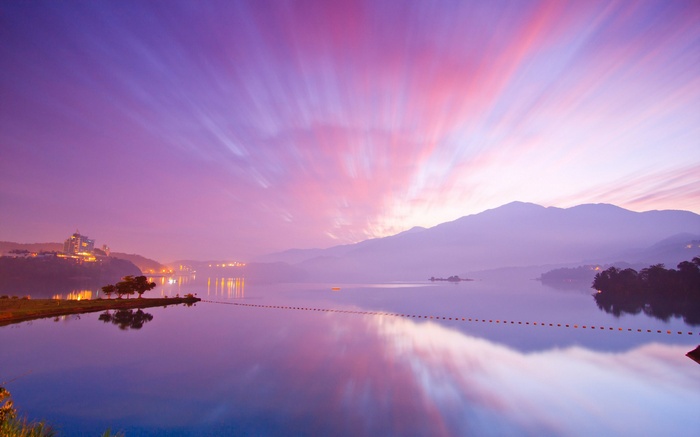 Purple Sunrise Over a Lake with Mountains