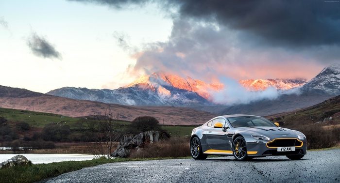 Aston Martin Vantage GT8 parked by a lake with mountains