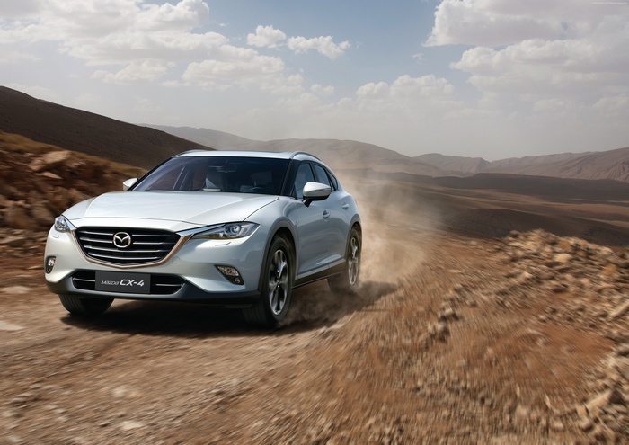 Silver Mazda CX-4 driving on a dirt road