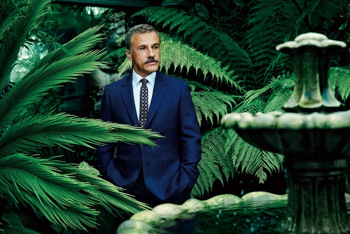 Christoph Waltz in a suit in a botanical garden