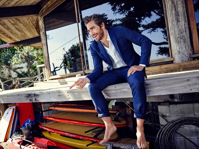 Jake Gyllenhaal in a blue suit on a wooden deck