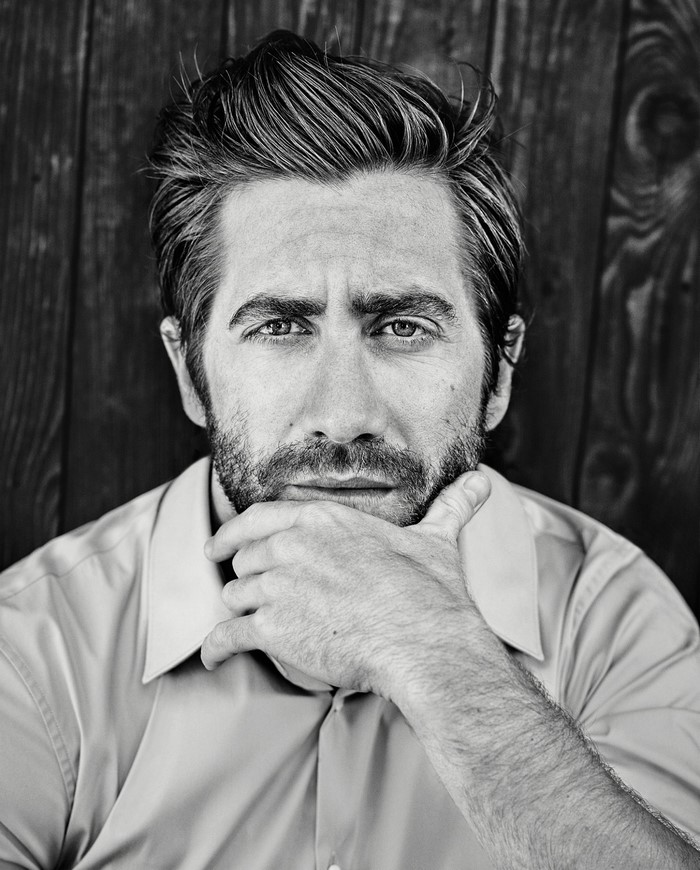 Jake Gyllenhaal portrait with beard and hand on chin