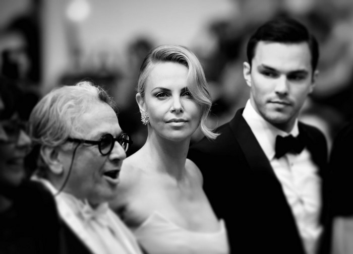 Charlize Theron, Nicholas Hoult, and George Miller at an event