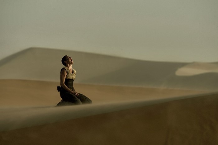 Furiosa from Mad Max: Fury Road screaming in the desert