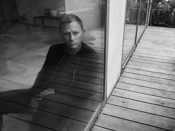 Daniel Craig sitting by a window