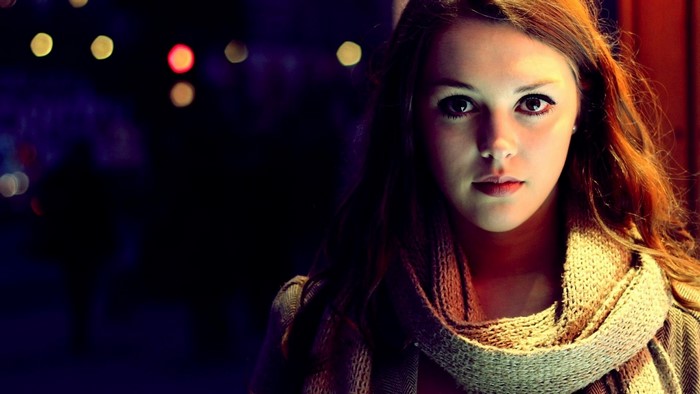 Young woman with auburn hair wearing a scarf