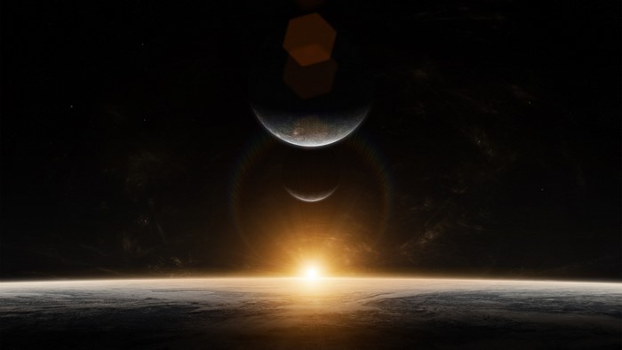 Sunrise over a planet with two moons in space