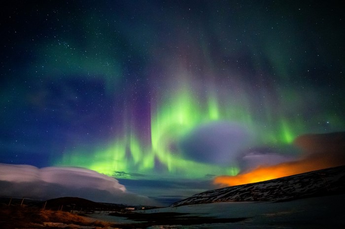 Aurora Borealis over a snowy landscape