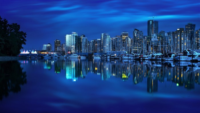 Vancouver cityscape at night with harbor reflections