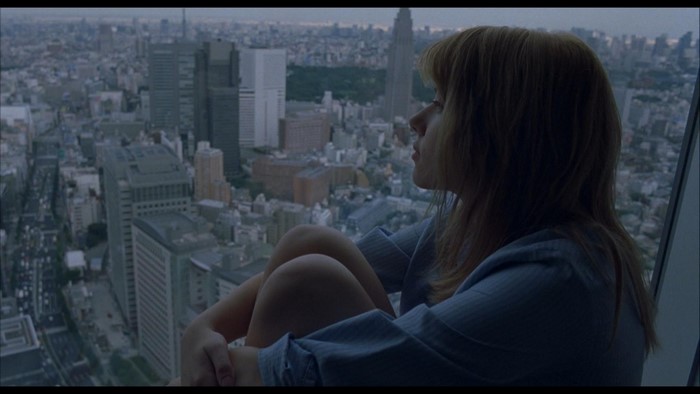 Woman looking out over a city skyline