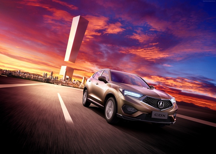 Acura CDX crossover on a road with city skyline and exclamation marks
