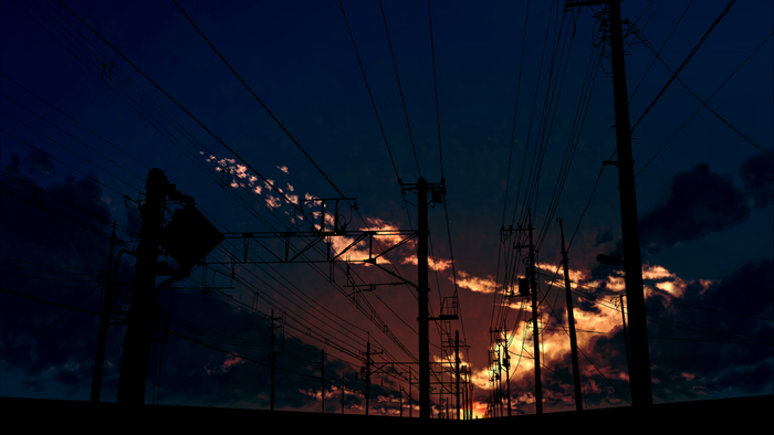 Silhouette of power lines against a dramatic sunset sky