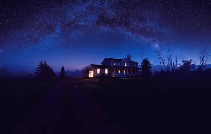 House under the Milky Way at night