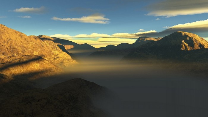 Misty mountain valley at sunrise or sunset