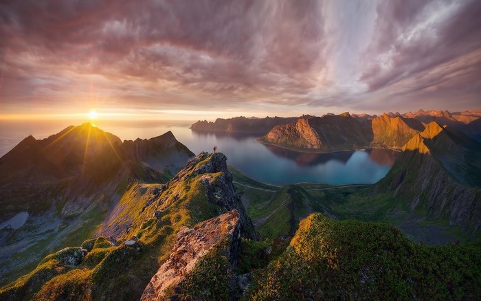 Mountain landscape with sun setting over the ocean