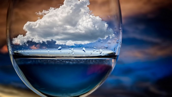 Cloud Reflection in Water-Filled Glass
