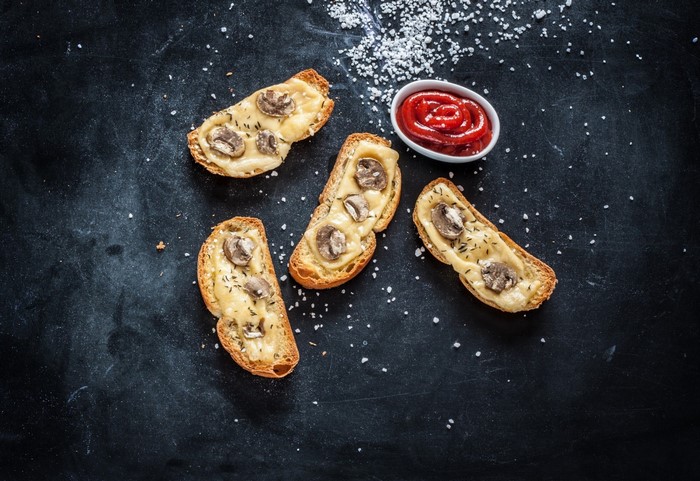Mushroom and cheese toasts with ketchup and salt
