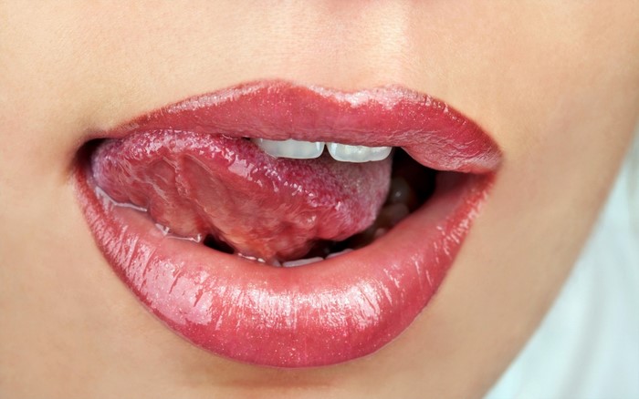 Close-Up of Glossy Red Lips and Tongue