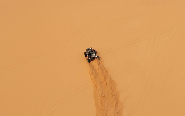 Buggy driving through sand dunes
