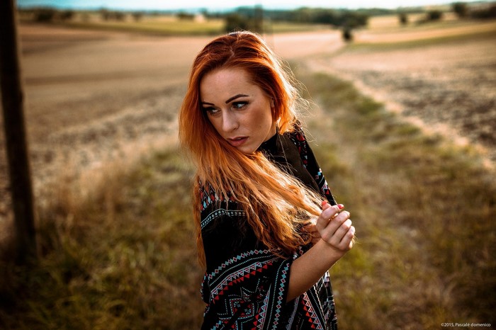 Woman with red hair in a field