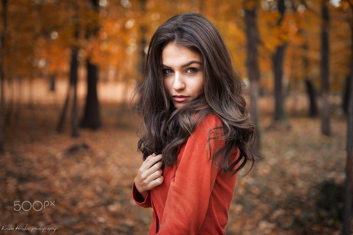 Woman in red sweater in autumn forest