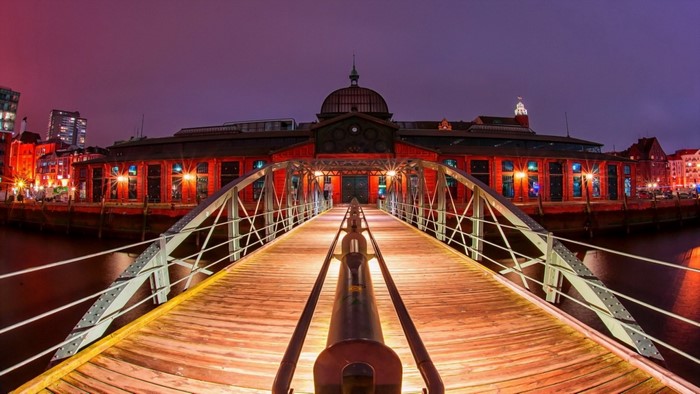 Bridge leading to historic building at night in Hamburg