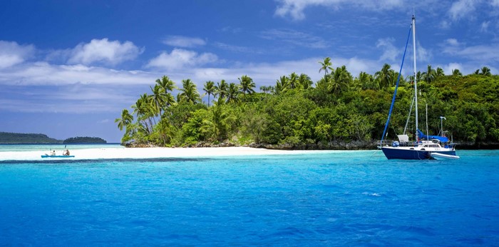 Tropical Island with Sailboat and Clear Blue Water