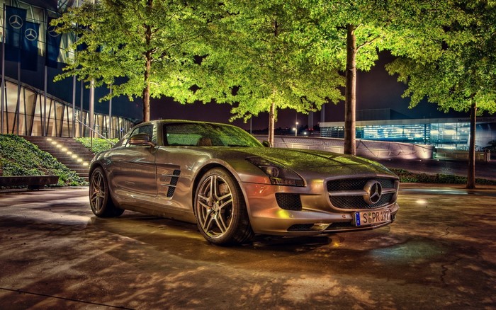 Mercedes-Benz SLS AMG parked outside Mercedes-Benz Museum at night