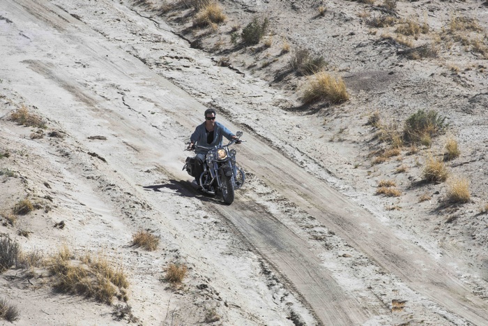 Man riding a motorcycle on a dirt path