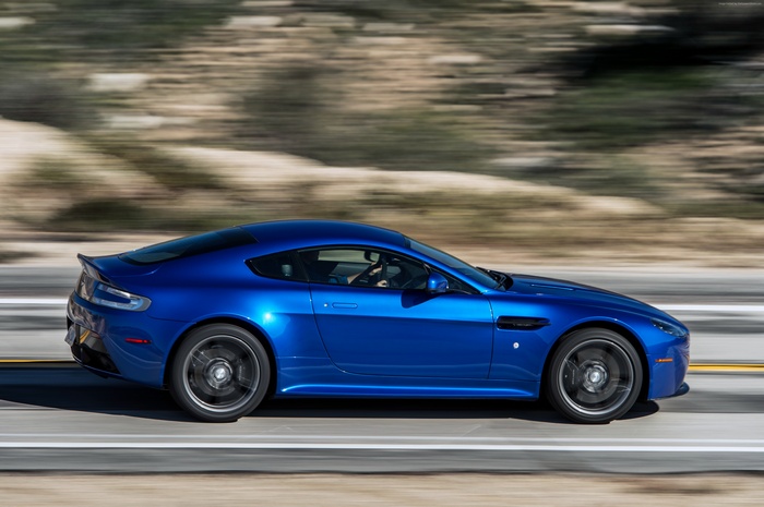 Blue Aston Martin V8 Vantage GTS driving on a road