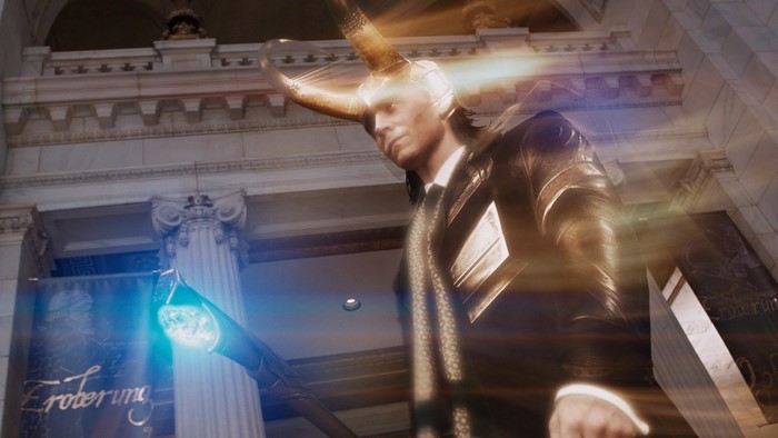 Loki holding the Tesseract in a building