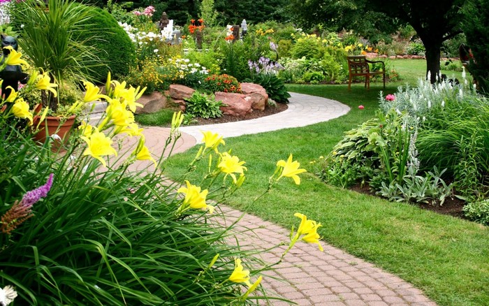 Beautiful garden with yellow flowers and a winding path