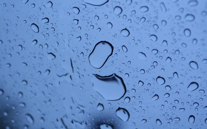 Water drops on a blue surface