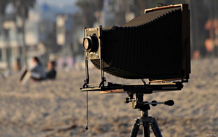 Large format camera on a tripod at the beach