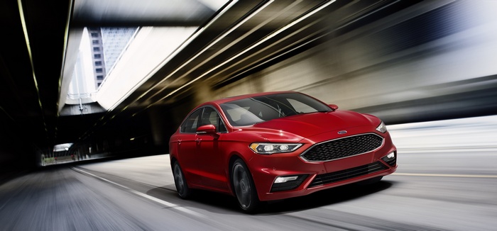Red Ford Fusion V6 Sport driving through tunnel