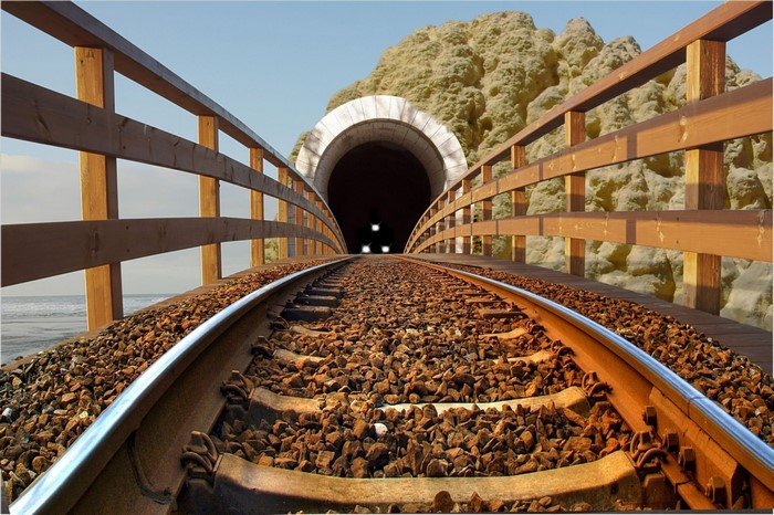 Train tracks leading to a tunnel entrance