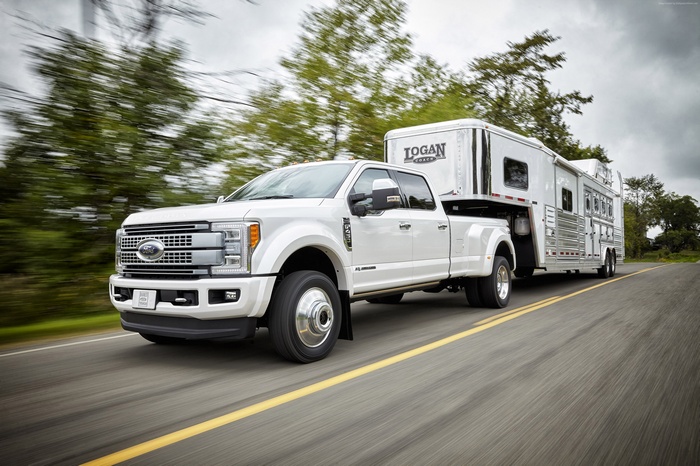 White Ford F450 Super Duty Platinum Crew Cab Truck Towing Trailer