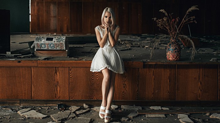 Woman in white dress on a ruined stage