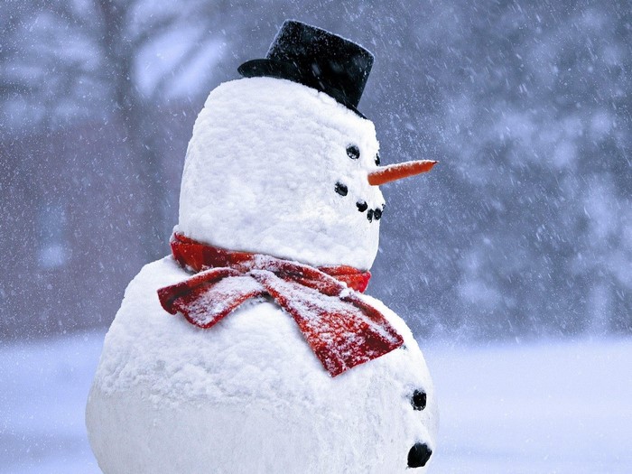 Snowman wearing a red scarf and black hat
