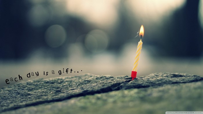 Birthday candle on a rock with text