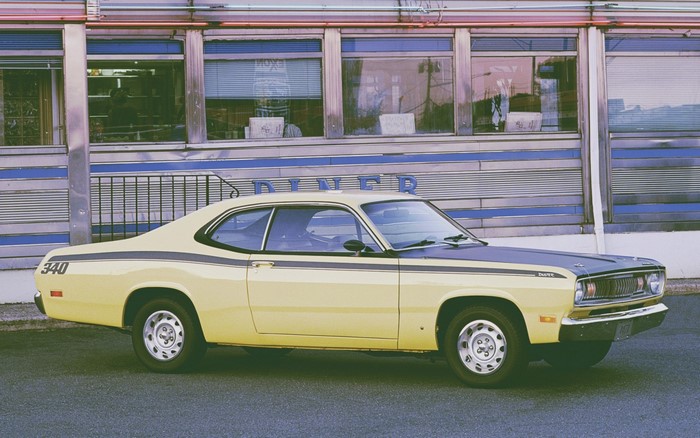 Yellow Plymouth Duster 340 parked in front of a diner