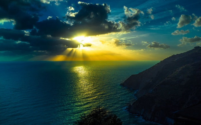 Sunset over the sea with coastal cliffs