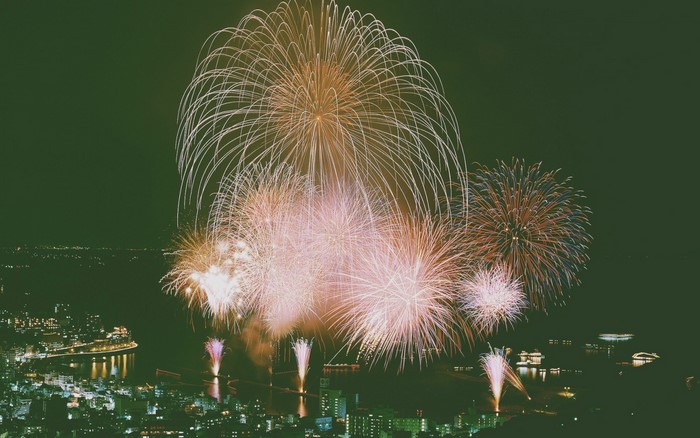 Fireworks display over a city at night
