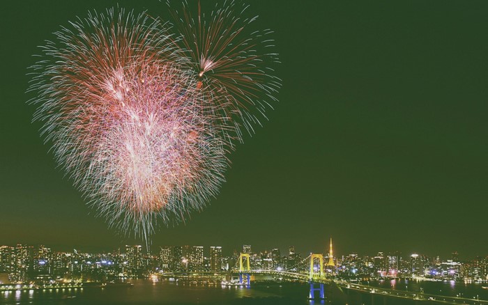 Fireworks over Tokyo cityscape with Rainbow Bridge