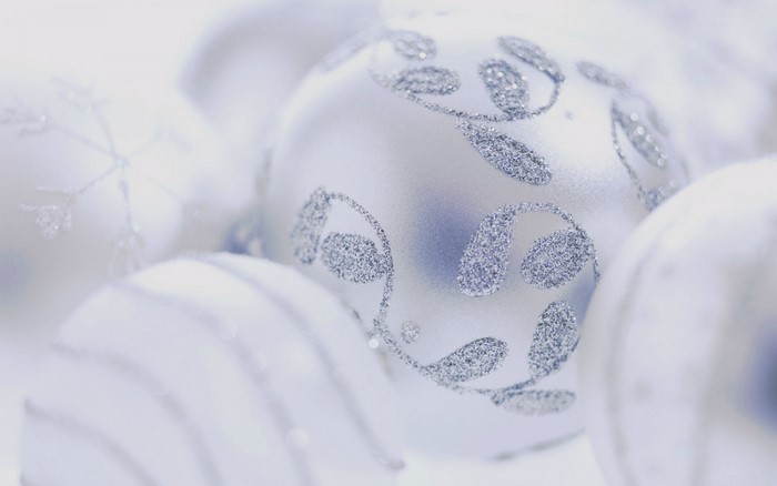 Close up of white Christmas ornaments with glitter