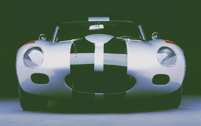 Silver Jaguar D-Type race car with racing stripes