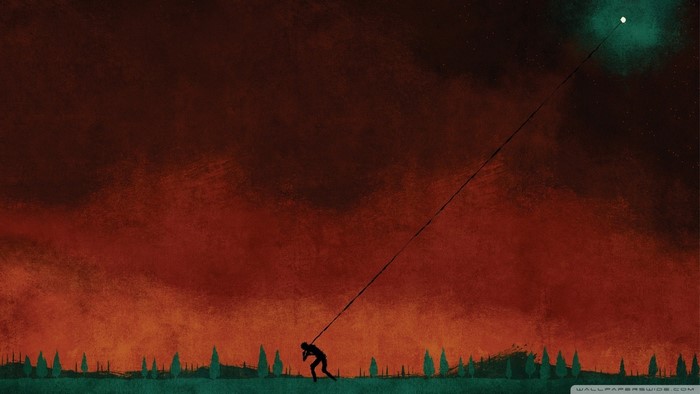 Silhouette of a person pulling a kite string towards a glowing orb